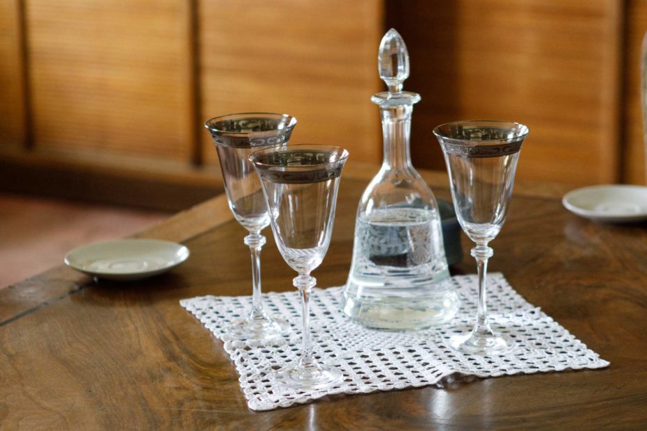 Three glasses and a decanter of water.
